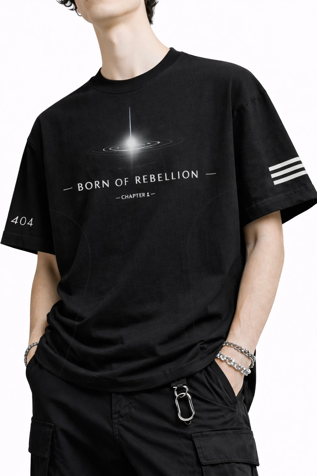 Person wearing a black t-shirt with 'Born of Rebellion' design on a white background
