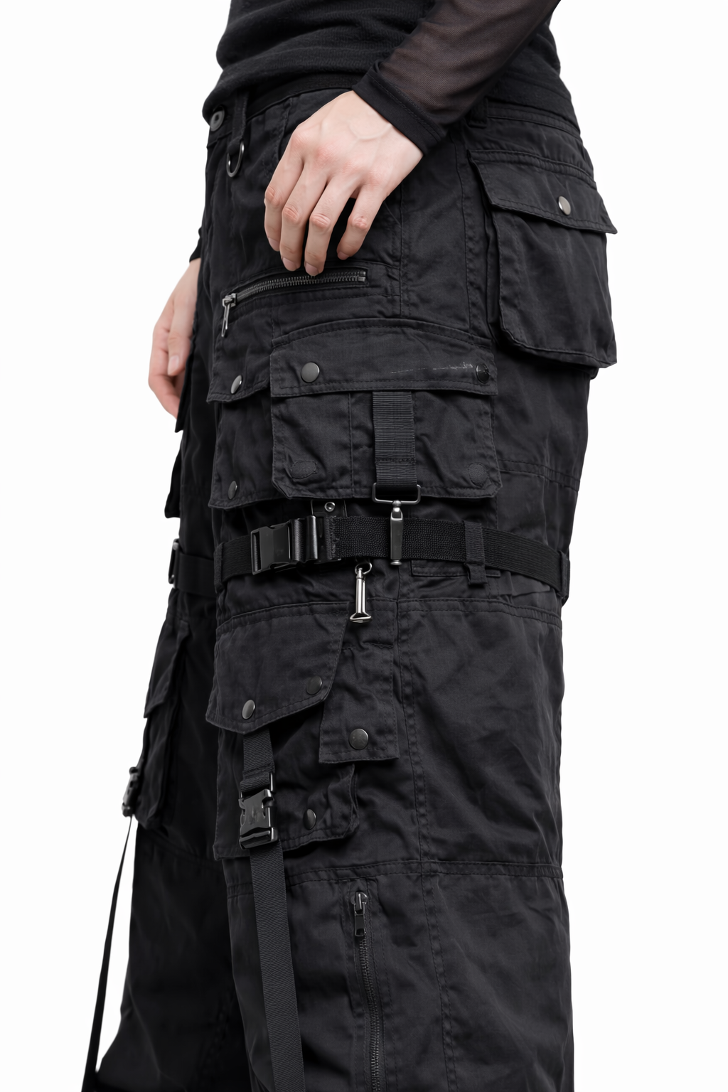 Black tactical pants with multiple pockets and zippers on a white background