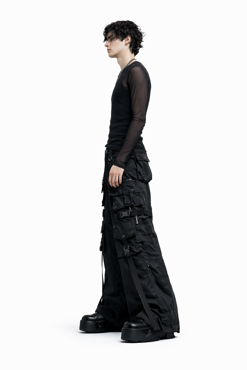 Person wearing a black outfit with wide-leg pants on a white background